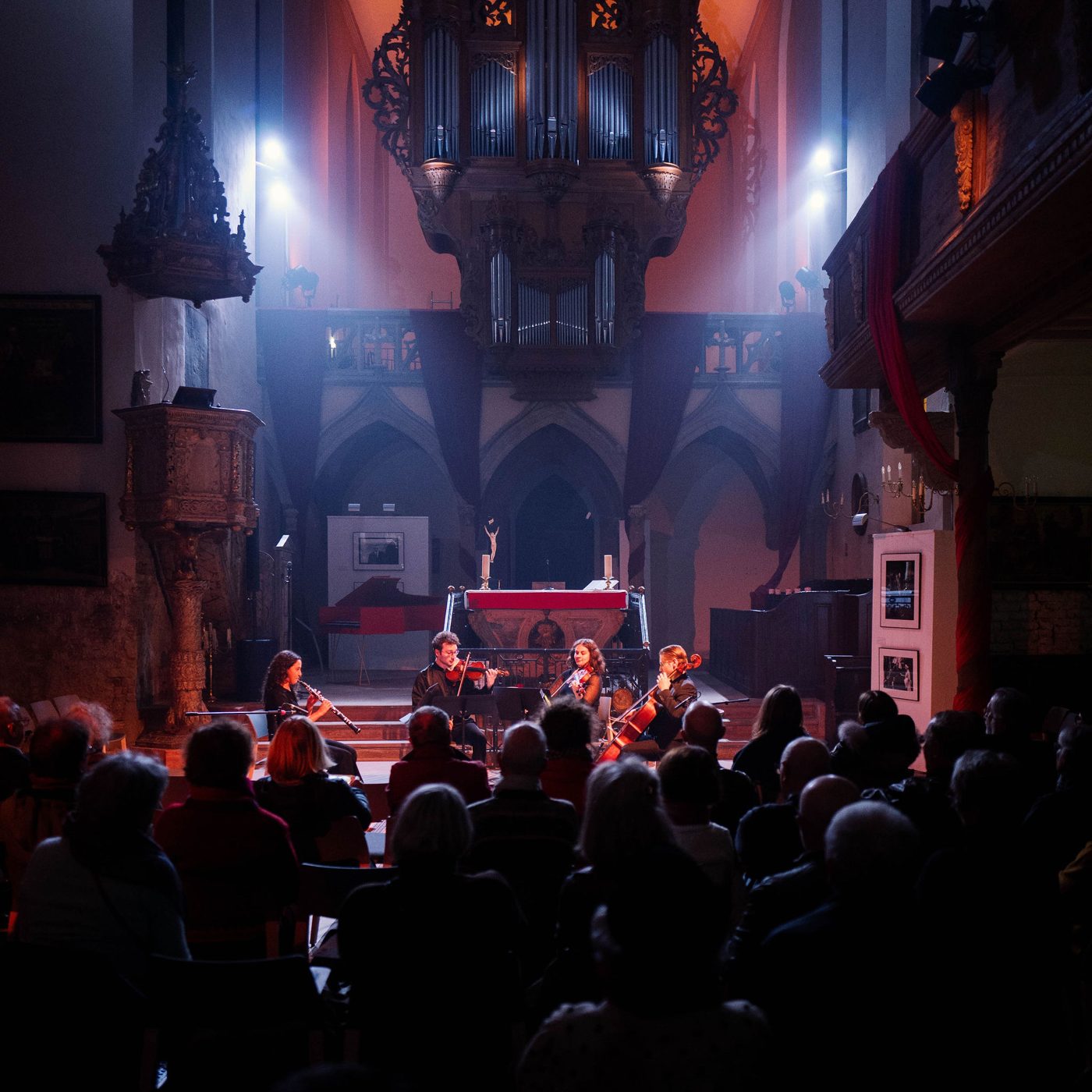 Rafaela Carvalho playing chamber music in a candlelit church